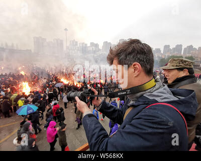 Chinese worshippers burn incense sticks to pray for wealth and happiness and worship the God of Wealth on the fifth day of the Chinese Lunar New Year Stock Photo