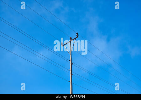 Electric pole and wires, wood electricty pole and cloudy blue sky Stock Photo
