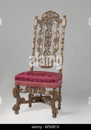 Chair with angled front legs, X-shaped cross and upholstery with flower pattern, Chair made of walnut, covered in bronze-colored pressed fabric flower pattern. The chair has angled front legs in the shape of broken S-volutes and rests on lion's claws that include spheres. The X-shaped cross has broken S-volutes, as well as the front cover. There is a button at the intersection. The high, open-worked back also shows S-volutes. The elongated center piece is decorated with circle and rosette in the middle and above and below with acanthus leaves and rosettes., anonymous, Netherlands, 1685 - 1700 Stock Photo