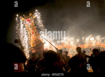 Chinese entertainers perform a fire dragon dance to celebrate the ...