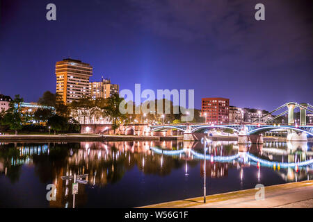 City of Frankfurt am Main in Germany seen at night with lights, river, buildings and bridge. Stock Photo