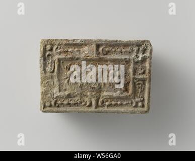 Fire brick depicting a mascaron between two fruit festivals, the whole surrounded by a fruit festival., anonymous, Antwerp (possibly), c. 1575 - c. 1600, earthenware, h 10 cm × w 14.5 cm × t 5.5 cm Stock Photo