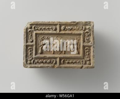 Fire brick depicting a mascaron between two fruit festivals, the whole surrounded by a fruit festival., anonymous, Antwerp (possibly), c. 1575 - c. 1600, earthenware, h 10 cm × w 14.5 cm × t 5.5 cm Stock Photo