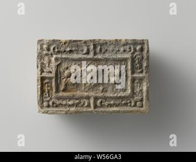 Fire brick depicting a mascaron between two fruit festivals, the whole surrounded by a fruit festival., anonymous, Antwerp (possibly), c. 1575 - c. 1600, earthenware, h 10 cm × w 14.5 cm × t 5.5 cm Stock Photo