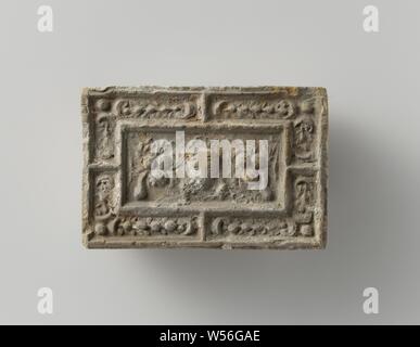 Fire brick depicting a mascaron between two fruit festivals, the whole surrounded by a fruit festival., anonymous, Antwerp (possibly), c. 1575 - c. 1600, earthenware, h 10 cm × w 14.5 cm × t 5.5 cm Stock Photo