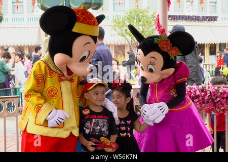 --FILE--Entertainers dressed in costumes of Mickey Mouse and Minnie Mouse perform during a parade at the Hong Kong Disneyland Resort in Hong Kong, Chi Stock Photo