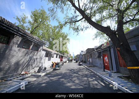 --FILE--Chinese construction workers pave the sidewalk in the Xizongbu Hutong in Dongcheng District in Beijing, China, 11 April 2018.   Xizongbu Huton Stock Photo