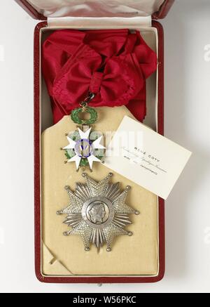 French knightly order (Legion d'Honneur), received by Willem Drees, Box covered with red leather, with the letters on the outside of the lid 'RF', in which the decorations of the Grand Cross of the Legion d'Honneur, Republic of France, granted to Prime Minister W. Drees. The Legion d'Honneur was founded in 1802 by Napoleon. The decorations consist of the order mark with shoulder strap and the order star. The order mark is a five-arm white enamelled star in gold, with a wreath of oak and bay leaves between the arms. The medallion in the center shows a woman's head and profile (symbol of Stock Photo