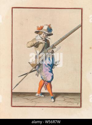 Soldier with a musket who brings his wick to his mouth to blow him clean Corte onderrechtinghe on the figuerliicke afbeeldinghe, soo much the right ghebruyck vant Musquet (original series title), A soldier, ten feet out, to the right, holding a musket (a certain type of firearm) with his left hand. With his right hand he brings a burning wick to his mouth to blow it clean. This print is part of the series of 43 hand-numbered prints of musketeers in the Wapenhandelhe, handling of weapons, military training, firearms: rifle, Jacob de Gheyn (II) (workshop of), The Hague, c. 1597 - 1607, paper Stock Photo