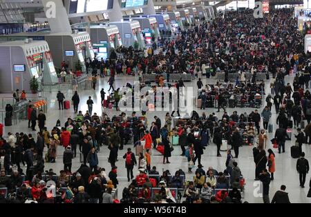 Chinese passengers who return to work from the Chinese Lunar New Year, also known as Spring Festival holiday, crowd the Hangzhou East railway station Stock Photo