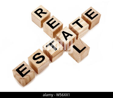 wooden cubes with inscription real estate on a white table Stock Photo