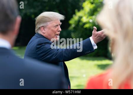 U.S President Donald Trump talks to members of the press  prior to boarding Marine One to begin his trip to West Virginia on the South Lawn of the White House July 24, 2019 in Washington, DC. Stock Photo