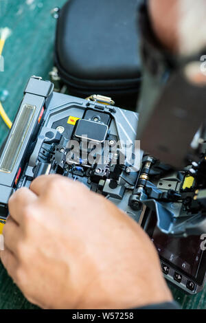 Device for mounting optical cable. Optical internet Technology concept. Optical fiber assembly. Stock Photo