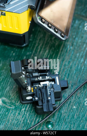 Device for mounting optical cable. Optical internet Technology concept. Optical fiber assembly. Stock Photo