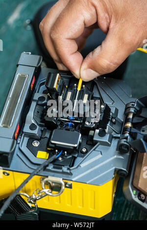 Device for mounting optical cable. Optical internet Technology concept. Optical fiber assembly. Stock Photo