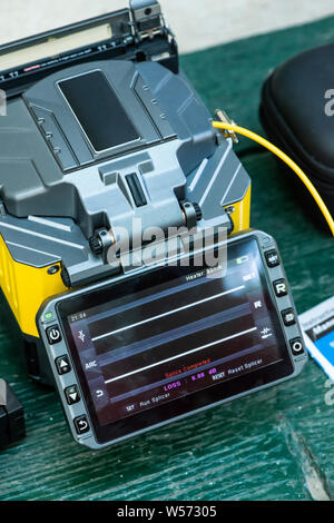 Device for mounting optical cable. Optical internet Technology concept. Optical fiber assembly. Stock Photo