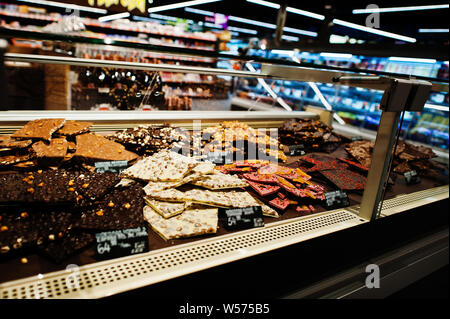 Chocolate tiles sweets store on showcase in factory store. Stock Photo