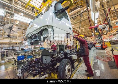 --FILE--Chinese workers assemble trucks on the assembly line at the ...