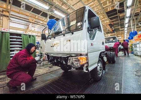 --FILE--Chinese workers assemble trucks on the assembly line at the ...