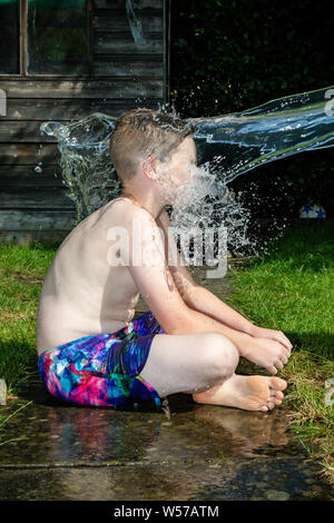 Teen boy with water Stock Photo by ©VaLiza 116935330
