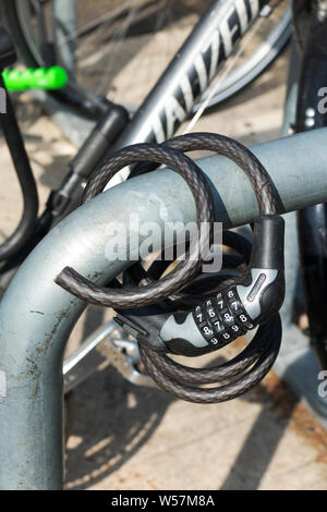 Bendy bicycle combination lock (Kryptonite brand) which has been cut by a cycle thief using wire cutters and left behind after the bike has been stolen. UK (111) Stock Photo