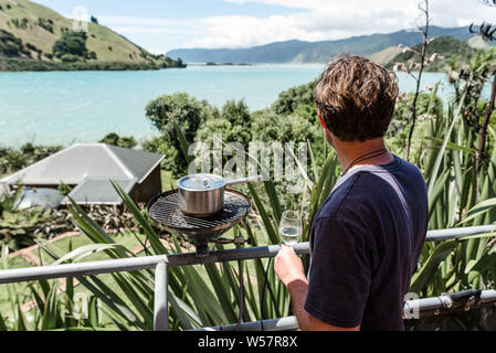 Man cooking outside overlooking beautiful view Stock Photo