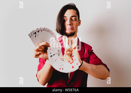Young magician juggling a deck of playing cards. Stock Photo