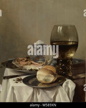 Still Life with a Salt, Still life with a bread and a fish on pewter plates. On the right a roemer, at the back a salt barrel. On the table are also a knife and some hazelnuts, laid table as still life, breakfast piece (Dutch: 'breakfast'), glass, rummer, salt-cellar, salt-shaker, salt, Pieter Claesz., c. 1640 - c. 1645, panel, oil paint (paint), painting, support: h 52.8 cm × w 44 cm Stock Photo
