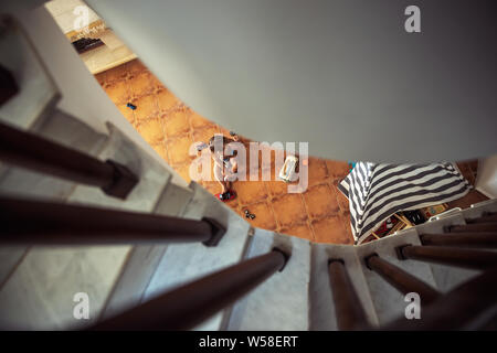 Top view from stairs on the little baby boy playing with toys, spy on the baby when he plays, spending happy time at home Stock Photo