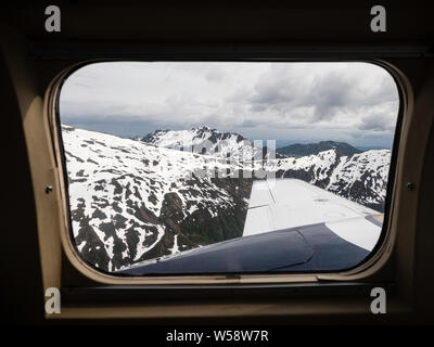 Aerial View of snow capped mountains as seen from a small private plane flying in Southeast Alaska, USA. Stock Photo
