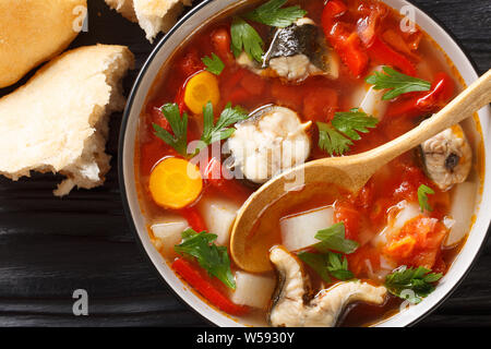 Vegetable soup with eel fish and tomatoes closeup in a bowl on the table. horizontal top view from above Stock Photo