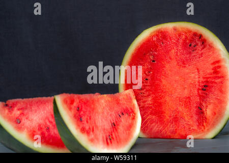 Watermelon cut and sliced black watermelon on black background Stock Photo