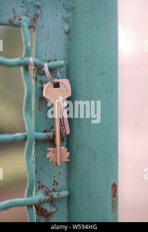 Bunch of two keys hanging on an old iron fence. Stock Photo