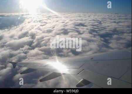 Sunshine above the cloud tops, climbing out of Gatwick Airport Stock Photo