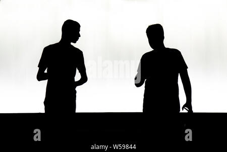 Belgrade, Serbia - July23, 2019: Silhouettes of two teenage boys walking  in the night, in high contrast black and white Stock Photo