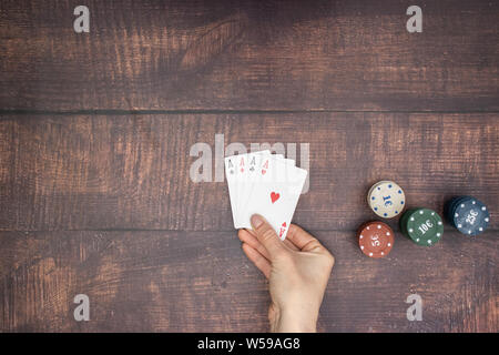 Woman's hand hold four aces Stock Photo