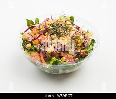 Closeup of a salad with purple cabbage and meat, corn and sliced vegetables in a glass bowl Stock Photo