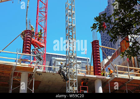Construction workers pouring cement. Stock Photo