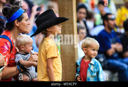 Cheyenne, USA. 26th July, 2019. People watch a performance at the Indian Village at the Cheyenne Frontier Days in Cheyenne, the United States, July 24, 2019. Cheyenne Frontier Days is held here from July 19 to 28, featuring rodeo events, concerts, parades and art shows. Credit: Li Ying/Xinhua/Alamy Live News Stock Photo