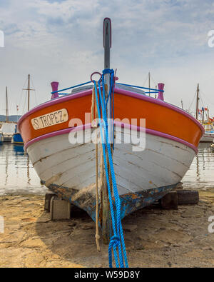 Old rowing boat on beach in traditional harbour of Saint Tropez, Cote d'Azur France Stock Photo