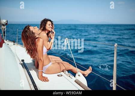 Young girl having fun on a yacht on vacation. Stock Photo