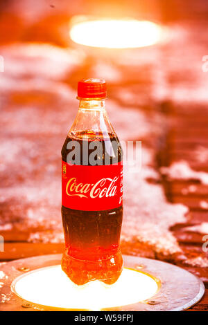 Classic Coca Cola bottle, Coca-Cola Company is the most popular market leader carbonated soft drink, winter, Stock Photo