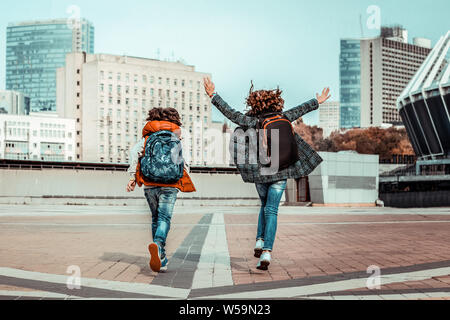 In one direction. Active pupils jumping while enjoying the beginning of their holiday Stock Photo
