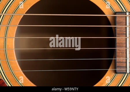 close macro view of the six frets  and sound hole on an acoustic wooden  guitar Stock Photo