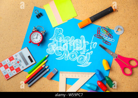 Back to school concept. Old alarm clock on the background with school supplies. Stock Photo