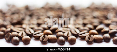 Banner for website. Close up beans on a white background. Coffee on the entire screen for the background. Roasted coffee beans brown. Lots of coffee i Stock Photo