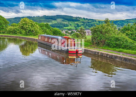 Narrowboat moored up in English rural countryside scenery on British waterway canal Stock Photo