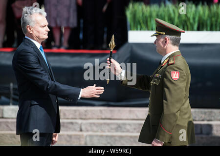 (190727) -- BEIJING, July 27, 2019 (Xinhua) -- Lithuanian President Gitanas Nauseda (L) presents the sceptre to new Chief of Defense Valdemaras Rupsys in Vilnius July 25, 2019. Lithuania's new Chief of Defense Valdemaras Rupsys took over his duties during the solemn inauguration ceremony on Thursday, pledging to further modernize the Armed Forces of Lithuania and improve readiness and maintenance of all military units. (Photo by Alfredas Pliadis/Xinhua) Stock Photo