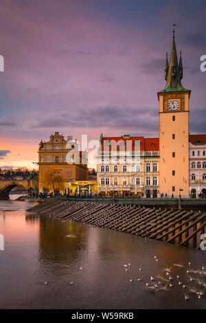 Prague, Czech Republic - March 8, 2019: Evening view of Old Town Water Tower and river Vltava.