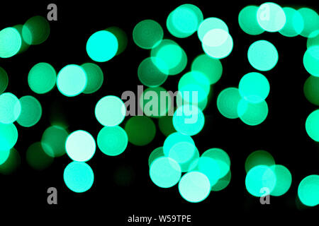 Unfocused abstract colourful bokeh black background. defocused and blurred many round blue light. Stock Photo